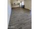 Open-concept living room featuring stylish wood-look tile flooring at 10582 W Oakmont Dr, Sun City, AZ 85351