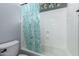 Bathroom features a white shower-tub combo with a light blue patterned shower curtain at 12725 W Forest Pleasant Pl, Peoria, AZ 85383