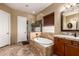 Bathroom featuring a soaking tub, tiled shower, and dual-sink vanity at 12725 W Forest Pleasant Pl, Peoria, AZ 85383