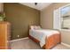 Bedroom featuring a cozy bed, neutral tones, and natural light at 12725 W Forest Pleasant Pl, Peoria, AZ 85383