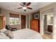 Cozy bedroom with a ceiling fan, a sitting chair, and direct pool access at 12725 W Forest Pleasant Pl, Peoria, AZ 85383