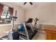 Exercise room showcasing a treadmill, elliptical machine, and natural light through the windows at 12725 W Forest Pleasant Pl, Peoria, AZ 85383