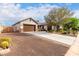 Charming single-story home featuring a stucco exterior, well-maintained landscaping, and a spacious driveway with an attached garage at 12725 W Forest Pleasant Pl, Peoria, AZ 85383