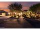 Charming home with a well-manicured front yard and cozy curb appeal at twilight at 12725 W Forest Pleasant Pl, Peoria, AZ 85383