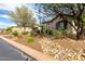 Desert landscaping with native plants surround this home, complemented by drought-tolerant greenery, enhancing curb appeal and water conservation at 12725 W Forest Pleasant Pl, Peoria, AZ 85383