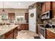 Stylish kitchen features stainless steel appliances, granite countertops, ample cabinet space, and views of the backyard at 12725 W Forest Pleasant Pl, Peoria, AZ 85383