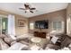 Cozy living room featuring a plush sectional sofa, ceiling fan, and sliding door to patio at 12725 W Forest Pleasant Pl, Peoria, AZ 85383
