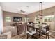 Open-concept living and dining area featuring comfortable seating and stylish lighting at 12725 W Forest Pleasant Pl, Peoria, AZ 85383