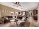 Inviting living room flows into the kitchen and boasts a comfortable brown sectional sofa at 12725 W Forest Pleasant Pl, Peoria, AZ 85383