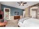 Spacious main bedroom featuring stone accents, a ceiling fan, and patio access at 12725 W Forest Pleasant Pl, Peoria, AZ 85383
