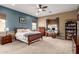 A serene main bedroom with a ceiling fan, a bed, and ample space for furniture at 12725 W Forest Pleasant Pl, Peoria, AZ 85383