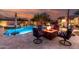 Backyard pool and spa with a seating area around a fire pit at 12725 W Forest Pleasant Pl, Peoria, AZ 85383