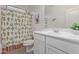 Bathroom featuring a white vanity, toilet, and a shower with a charming cactus-themed curtain at 18388 W Ida Ln, Surprise, AZ 85387