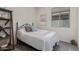 Cozy bedroom with a comfortable bed, decorative shelves, and a bright window at 18388 W Ida Ln, Surprise, AZ 85387