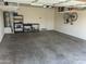 Spacious garage with overhead storage racks, shelving units, and water heater for optimal organization at 18388 W Ida Ln, Surprise, AZ 85387
