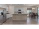 Spacious kitchen features stainless steel appliances, granite island, and dining area at 18388 W Ida Ln, Surprise, AZ 85387