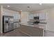 Bright kitchen boasts stainless steel appliances and large island with granite countertops at 18388 W Ida Ln, Surprise, AZ 85387