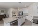 Open-concept kitchen with island, stainless appliances, and ample white cabinetry at 18388 W Ida Ln, Surprise, AZ 85387