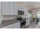 Modern kitchen with stainless steel appliances, granite countertops, and ample cabinet space at 18388 W Ida Ln, Surprise, AZ 85387