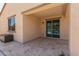 Covered patio featuring a durable storage box and sliding doors that lead to the home's interior at 18388 W Ida Ln, Surprise, AZ 85387