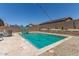 Backyard swimming pool surrounded by desert landscaping, string lights, and an outdoor seating area at 18388 W Ida Ln, Surprise, AZ 85387
