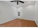 Bedroom features wood floors, ceiling fan, neutral paint, and bright window at 1850 E Maryland Ave # 18, Phoenix, AZ 85016