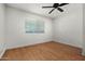 Bedroom features wood floors, ceiling fan, neutral paint, and bright window at 1850 E Maryland Ave # 18, Phoenix, AZ 85016