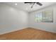 Bedroom features wood floors, ceiling fan, neutral paint, and bright window at 1850 E Maryland Ave # 18, Phoenix, AZ 85016
