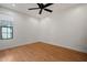 Bedroom features wood floors, ceiling fan, neutral paint, and bright window at 1850 E Maryland Ave # 18, Phoenix, AZ 85016