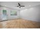 Bedroom with neutral tile flooring, ceiling fan, natural light, and white walls at 1850 E Maryland Ave # 18, Phoenix, AZ 85016