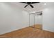 Clean bedroom with neutral paint, hardwood floors, mirrored closet and ceiling fan at 1850 E Maryland Ave # 18, Phoenix, AZ 85016