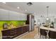Modern kitchen featuring sleek cabinetry, stainless steel appliances, granite countertops, and a vibrant green backsplash at 1850 E Maryland Ave # 18, Phoenix, AZ 85016