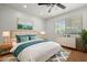 Bright main bedroom featuring a large bed, white comforter, soft blue pillows, and a view of the outdoors at 1850 E Maryland Ave # 18, Phoenix, AZ 85016