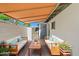 Inviting patio area with comfortable seating, a retractable shade, and a quaint garden view for relaxing at 1850 E Maryland Ave # 18, Phoenix, AZ 85016