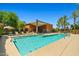 Community pool with lounge chairs, landscaping, and blue sky backdrop for relaxation and enjoyment at 1850 E Maryland Ave # 18, Phoenix, AZ 85016