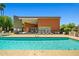 Community pool with lounge chairs and covered area for relaxing by the water on a sunny day at 1850 E Maryland Ave # 18, Phoenix, AZ 85016