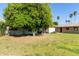 Lush backyard with trees, an area for sitting and a well maintained lawn at 18842 N Lakeforest Dr, Sun City, AZ 85373