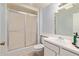 Bathroom featuring a shower over tub, toilet, sink, and a mirror at 18842 N Lakeforest Dr, Sun City, AZ 85373