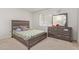 Bedroom featuring a bed, dresser, and a window at 18842 N Lakeforest Dr, Sun City, AZ 85373