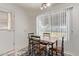 Cozy dining area with a wooden table set and a large window offering natural light at 18842 N Lakeforest Dr, Sun City, AZ 85373