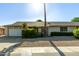 Charming single-story home with a well-maintained front yard, attached garage and desert landscaping at 18842 N Lakeforest Dr, Sun City, AZ 85373