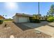 Single-story home boasts a two-car garage, desert landscaping and a well-kept front yard at 18842 N Lakeforest Dr, Sun City, AZ 85373