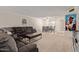 Spacious living room flows into the dining area, featuring a plush sectional sofa at 18842 N Lakeforest Dr, Sun City, AZ 85373