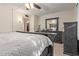 Main bedroom featuring a king-size bed, ceiling fan, and closet at 18842 N Lakeforest Dr, Sun City, AZ 85373