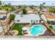 Aerial view of a backyard featuring a pool, covered patio with table, and fire pit with lounge chairs at 19414 N 3Rd Ave, Phoenix, AZ 85027