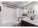 Cozy bathroom with tub, shower, and vanity with white countertop and dark wood cabinets at 19414 N 3Rd Ave, Phoenix, AZ 85027