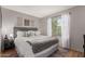 Bedroom with a gray upholstered bed, side tables, and window at 19414 N 3Rd Ave, Phoenix, AZ 85027