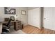 Cozy bedroom featuring a wooden desk, decorative map, and closet with sliding doors, perfect for a home office setup at 19414 N 3Rd Ave, Phoenix, AZ 85027