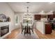 Bright dining room featuring wood floors, fireplace, and views of the outdoor pool through sliding glass doors at 19414 N 3Rd Ave, Phoenix, AZ 85027
