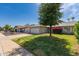Single-story home with a two-car garage, green lawn, and manicured shrubbery on a residential street at 19414 N 3Rd Ave, Phoenix, AZ 85027